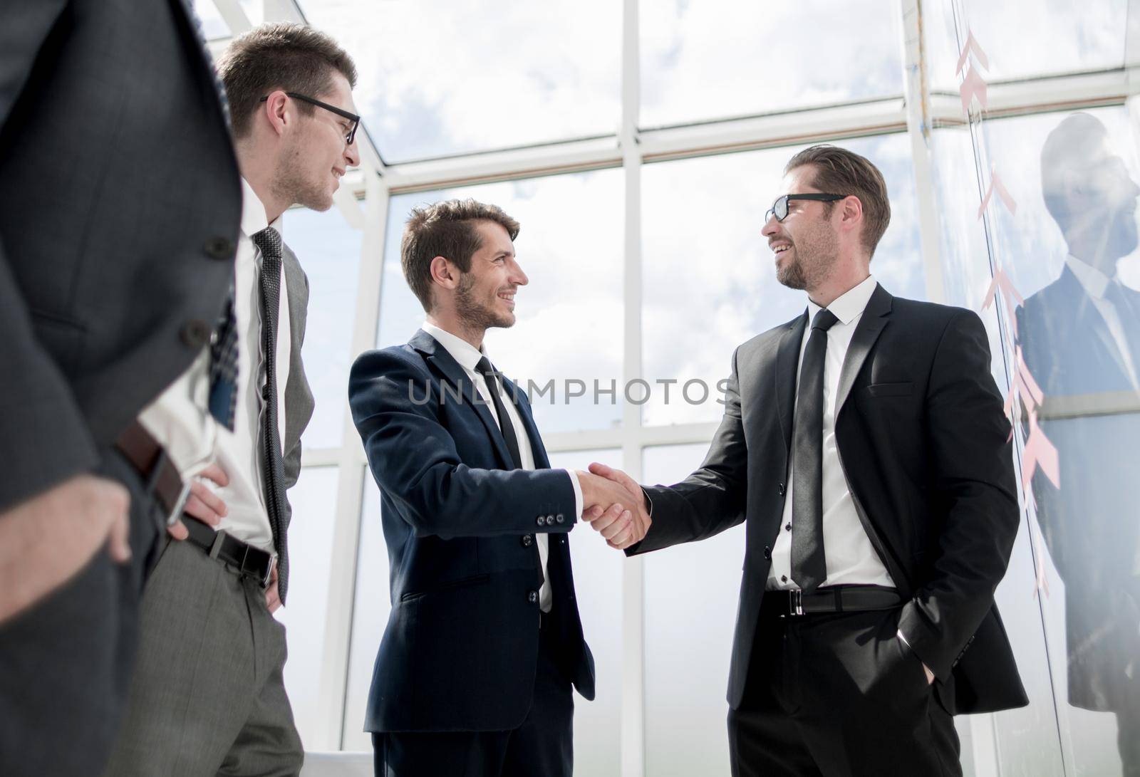 handshake of business people standing in modern office. the concept of cooperation