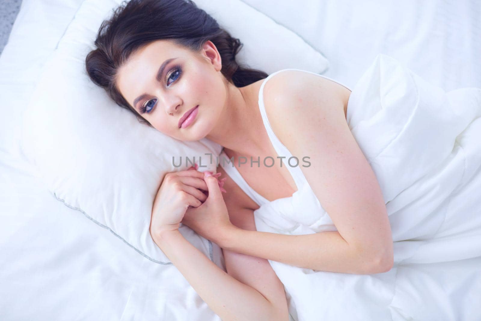 Young beautiful woman lying in bed