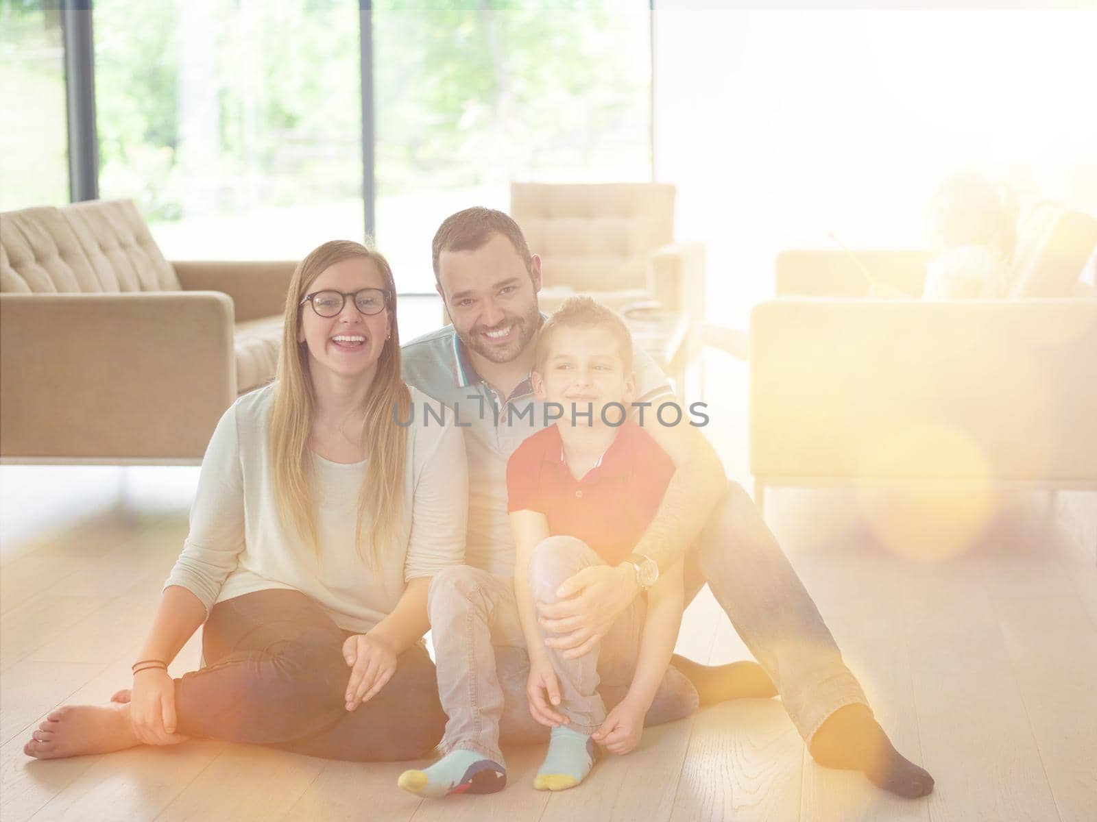 happy young family with little boy enjoys in the modern living room of their luxury home villa