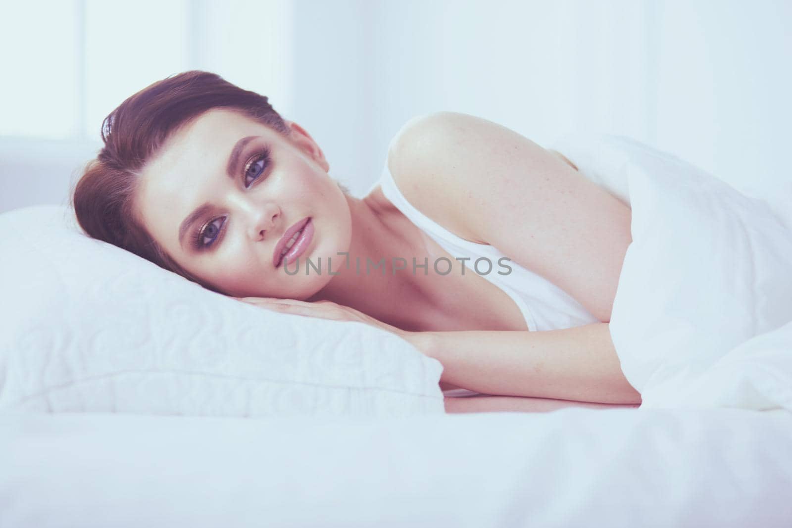 Young beautiful woman lying in bed