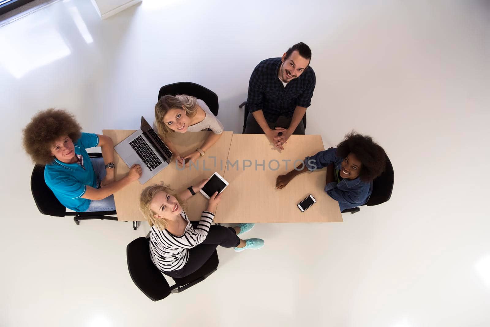 Multiethnic startup business team on meeting  top view by dotshock
