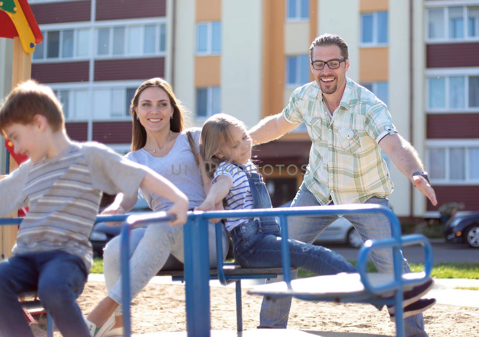 modern young family with children playing in the Playground.family holiday concept