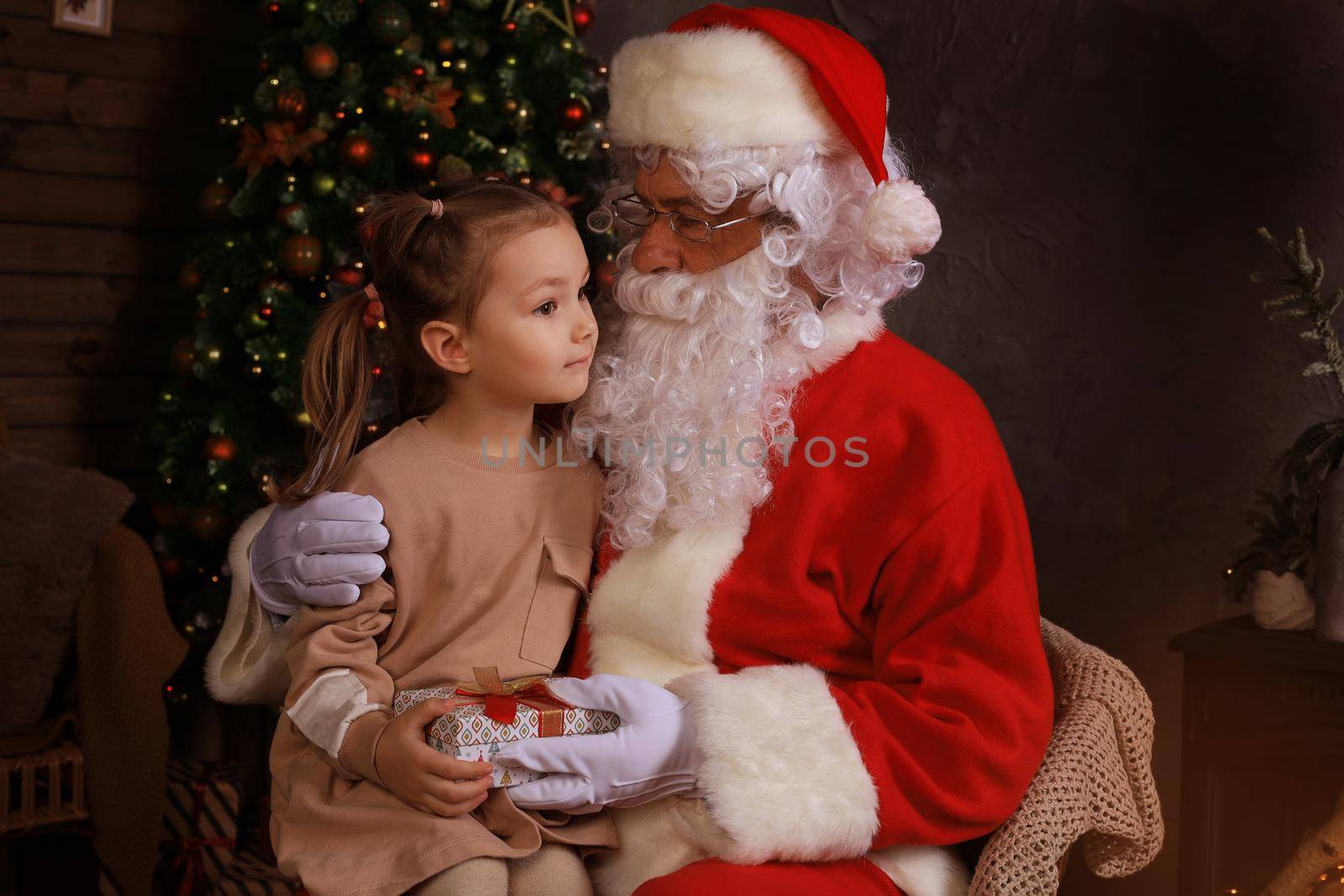 Santa Claus and child at home. Christmas gift. Family holiday concept. by tsyhun