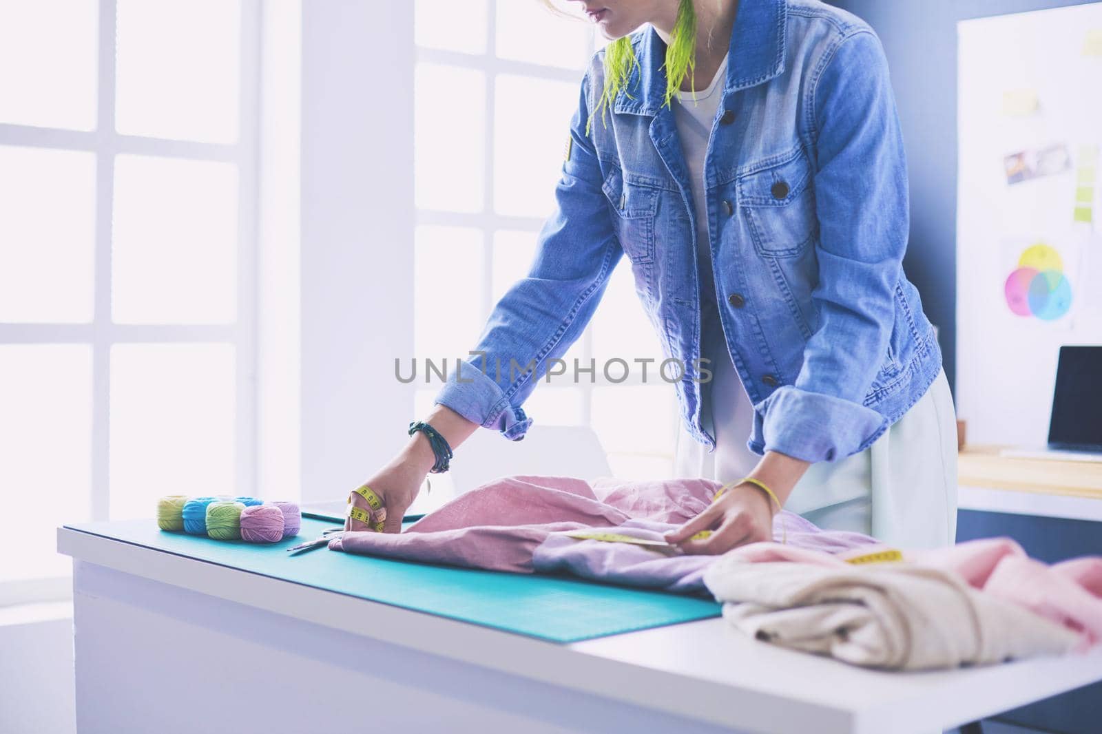 Fashion designer woman working on her designs in the studio.
