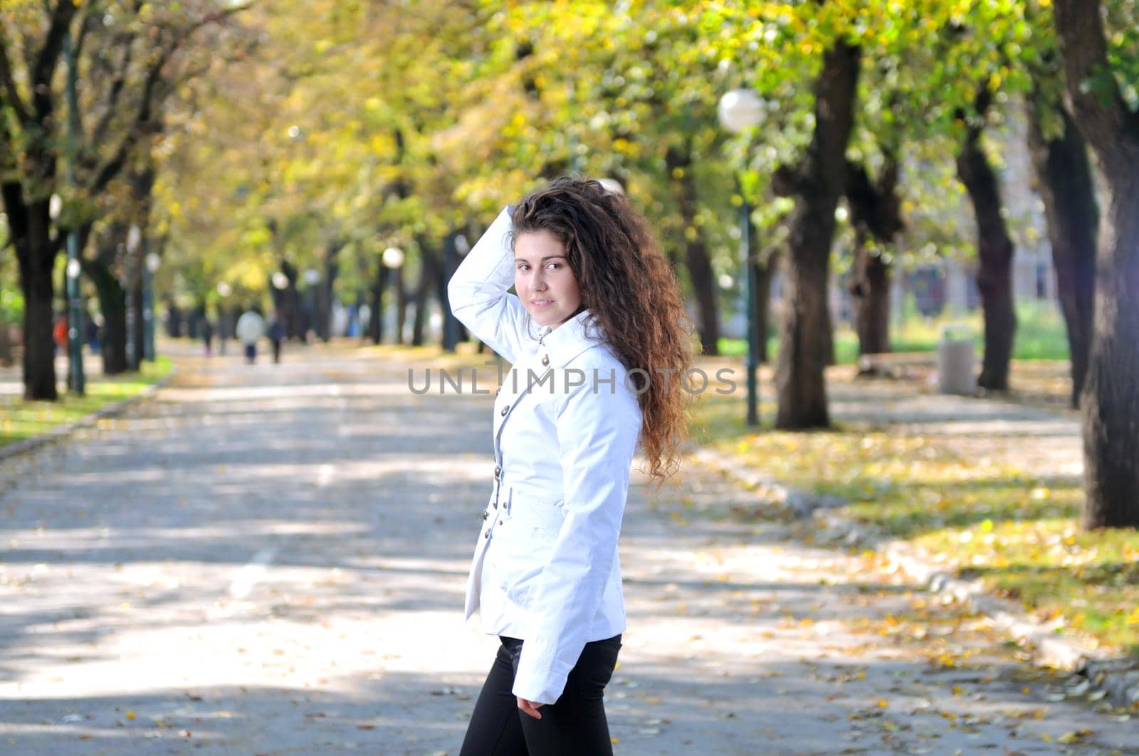 brunette Cute young woman smiling outdoors in nature by dotshock