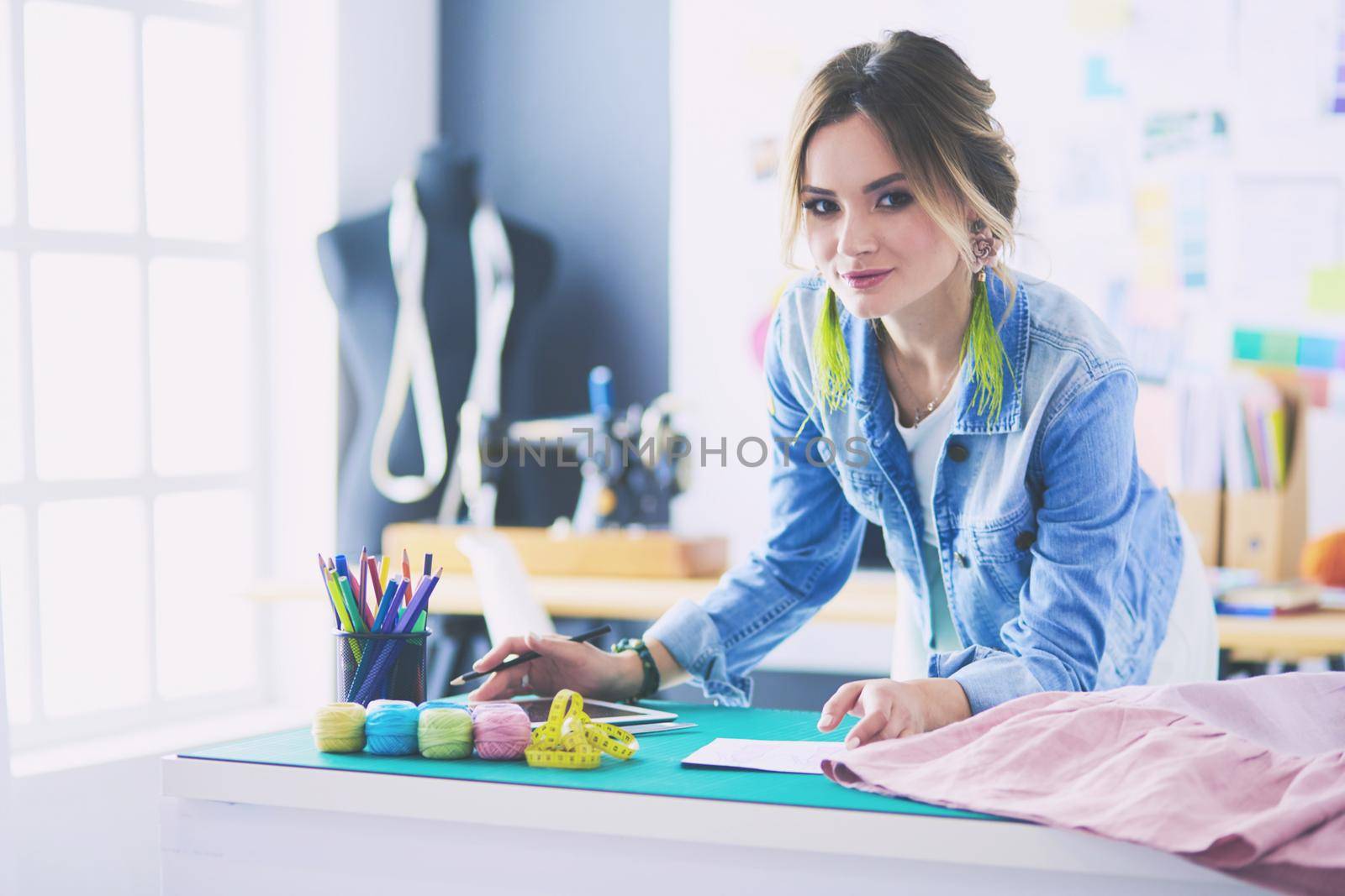 Fashion designer woman working on her designs in the studio.