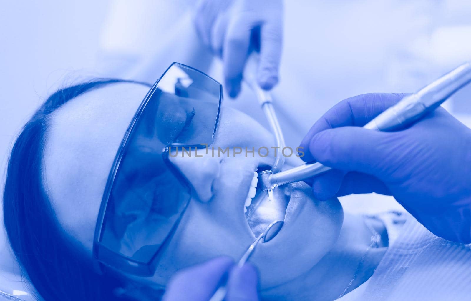 Dental team and patient at dentist's surgery.