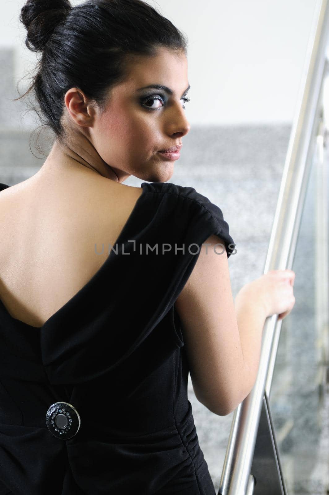 beautiful young lady in black dress shoot from back