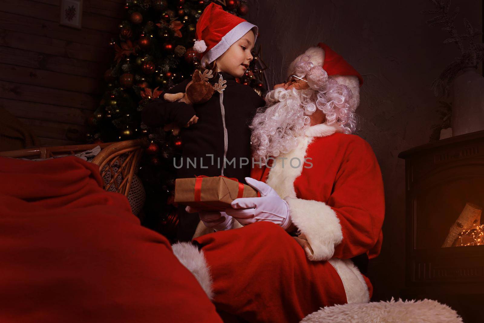 Santa Claus and child at home. Christmas gift. Family holiday concept