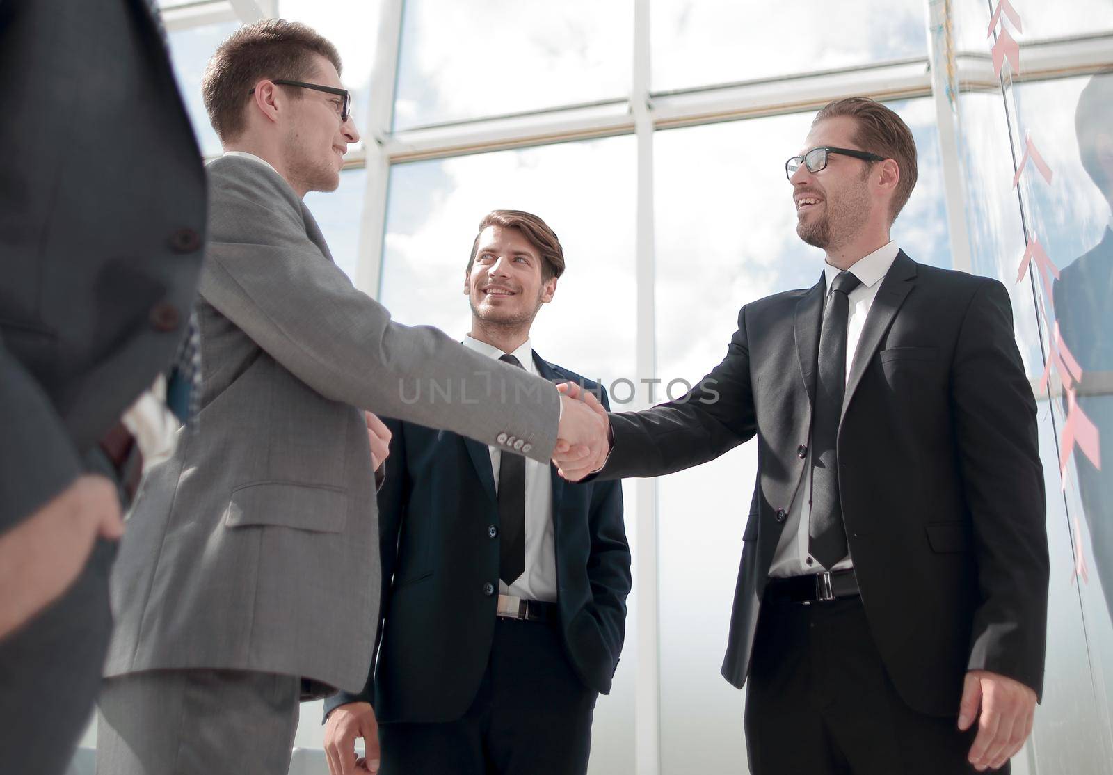 handshake business partners standing in a modern office. the concept of cooperation
