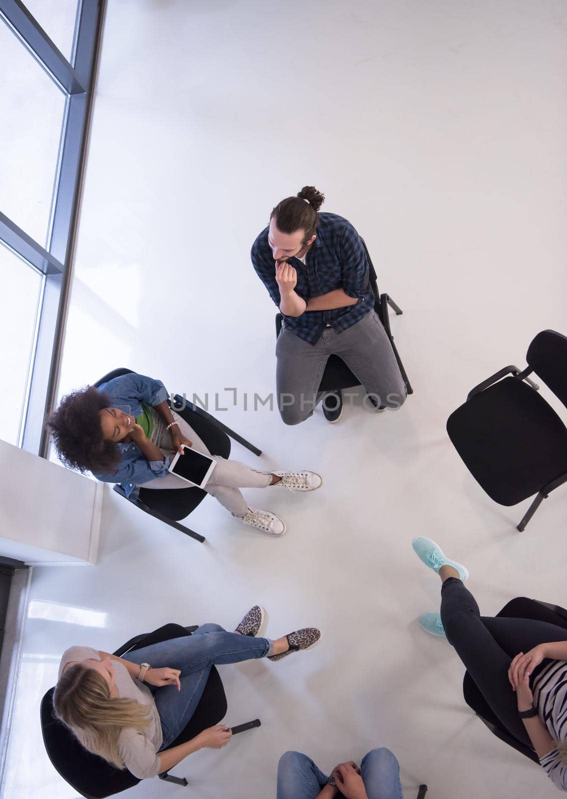 Multiethnic startup business team on meeting  top view by dotshock