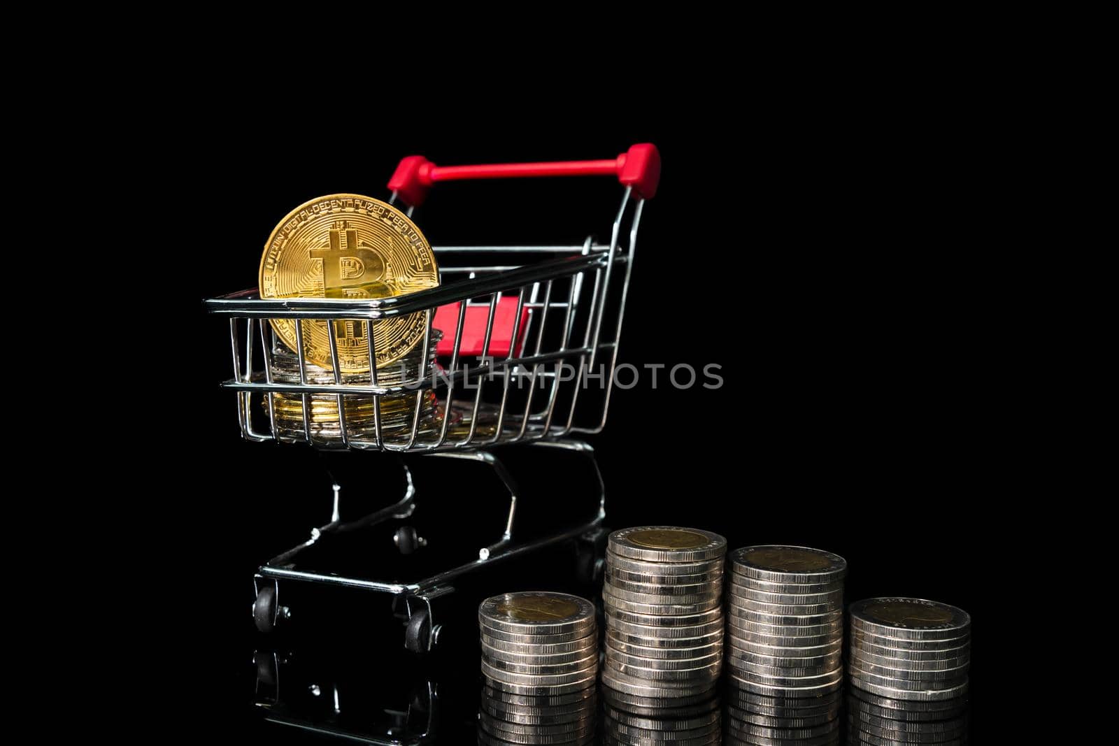Bitcoin coin in shopping cart on black background by stoonn