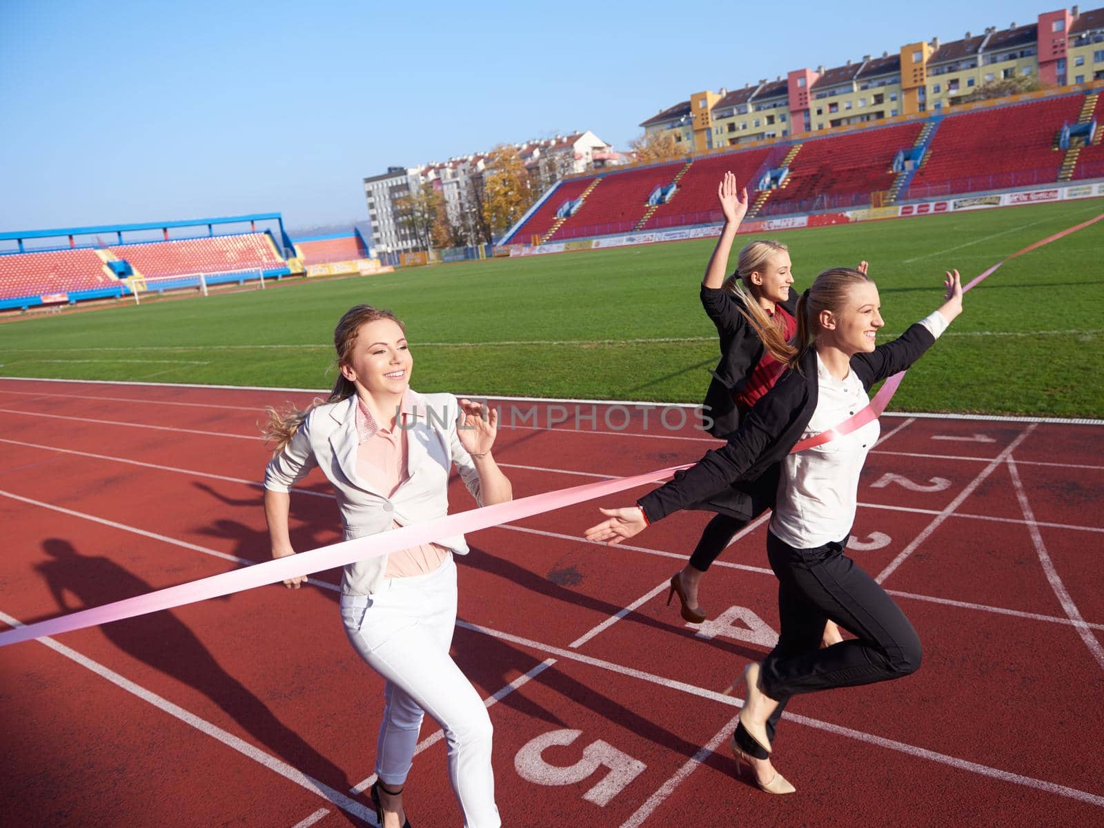 business people running together on  athletics racing track