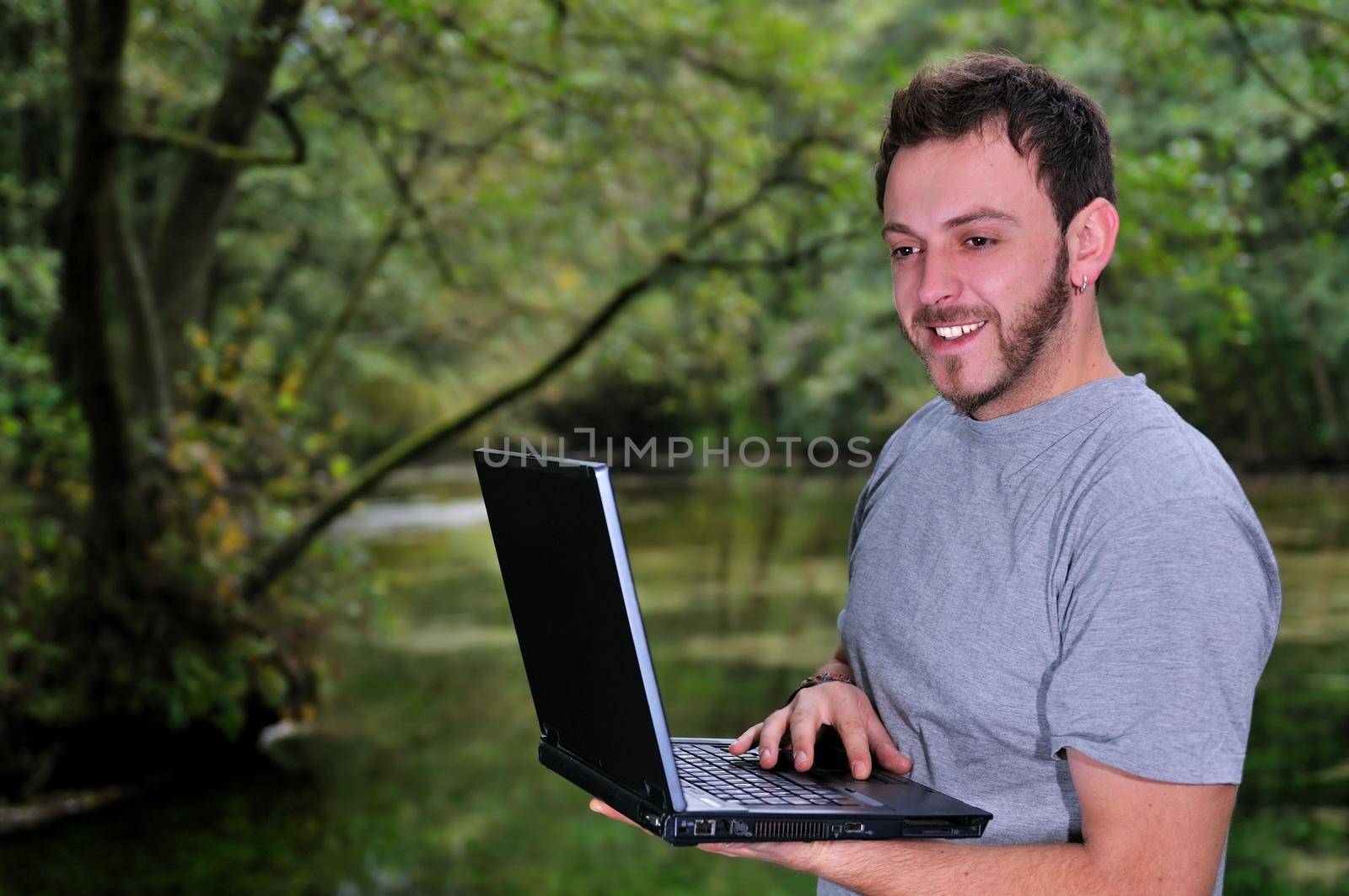 young businessman with  laptop outdoor by dotshock