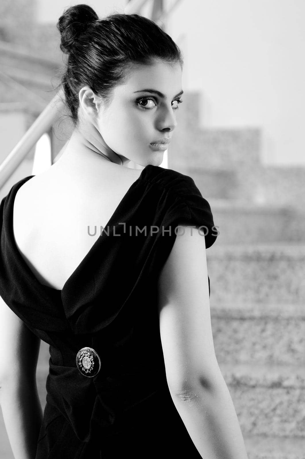 beautiful young lady in black dress shoot from back