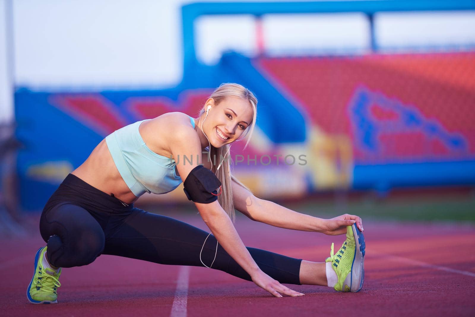 sporty woman on athletic race track by dotshock