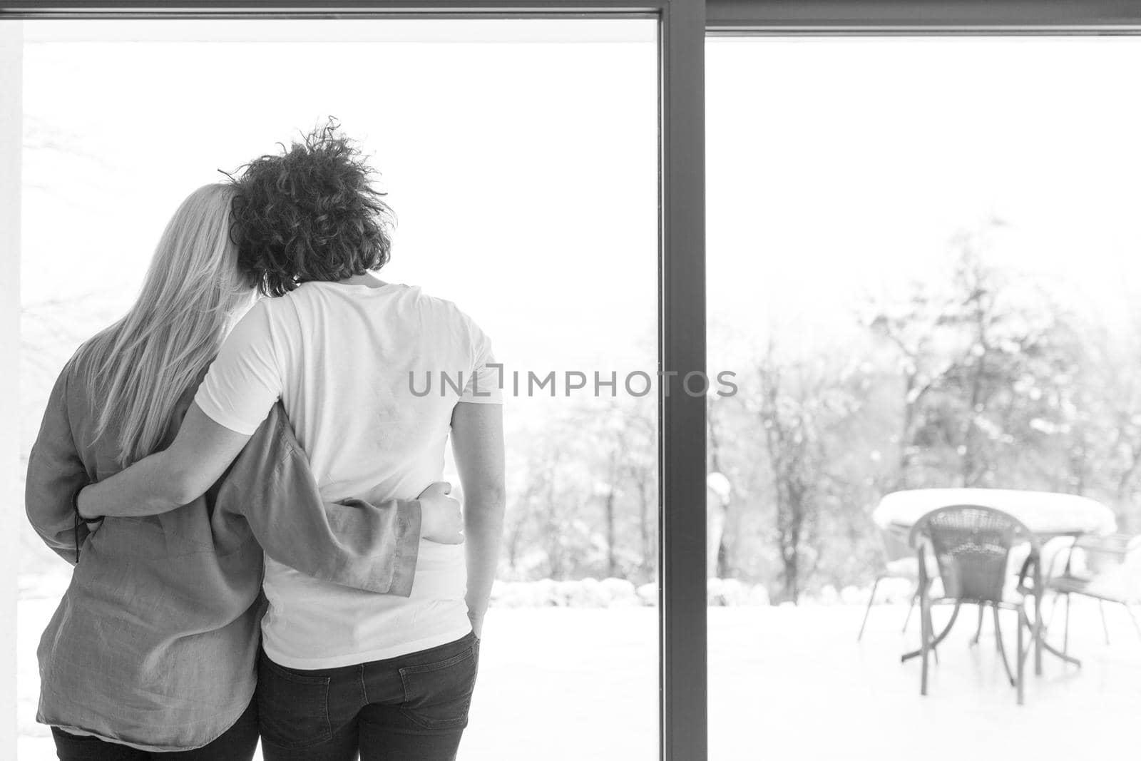 young couple enjoying morning coffee by the window by dotshock