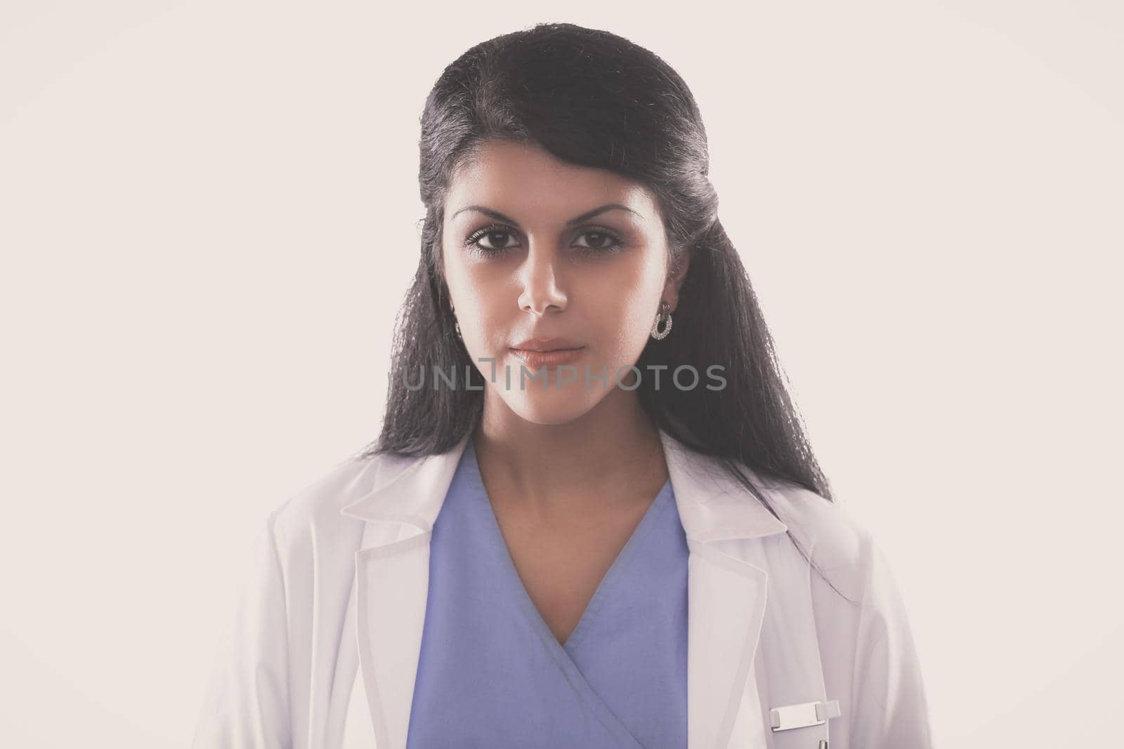 Young doctor or medic with clipboard and stethoscope standing on white background.