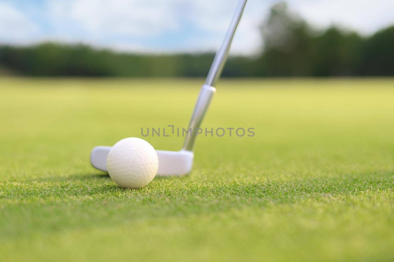 Golf approach shot with iron from fairway at sunny day. by tsyhun