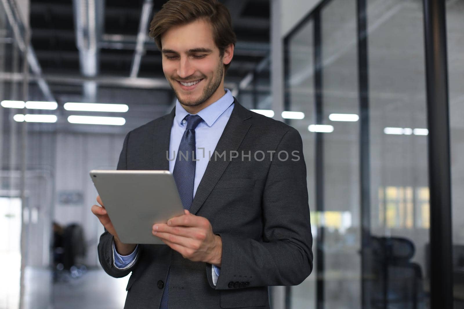 Young man using his tablet in the office.