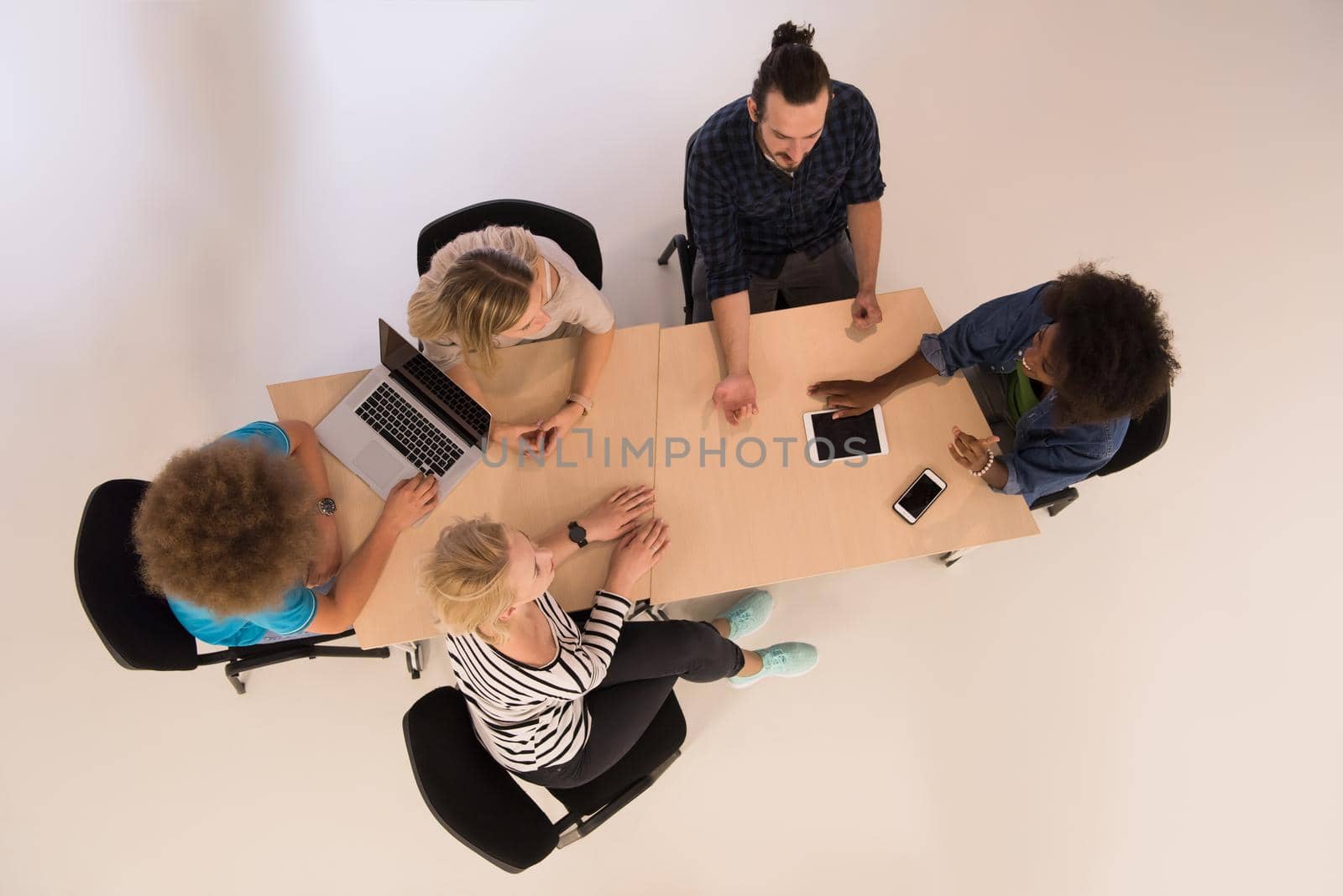 Multiethnic startup business team on meeting  top view by dotshock