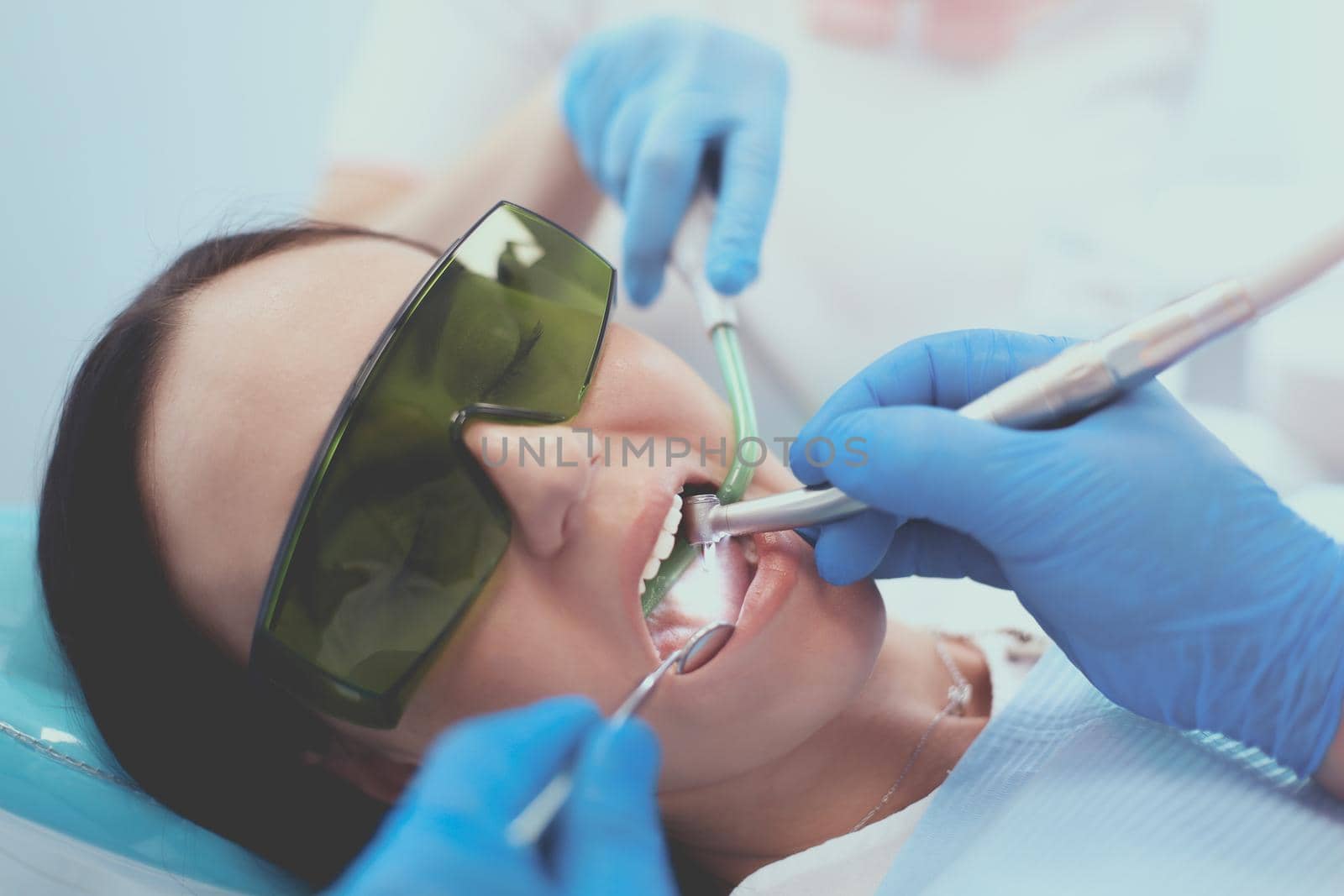 Dental team and patient at dentist's surgery.