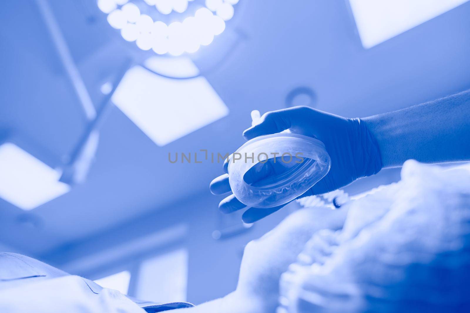 Man surgeon at work in operating room.