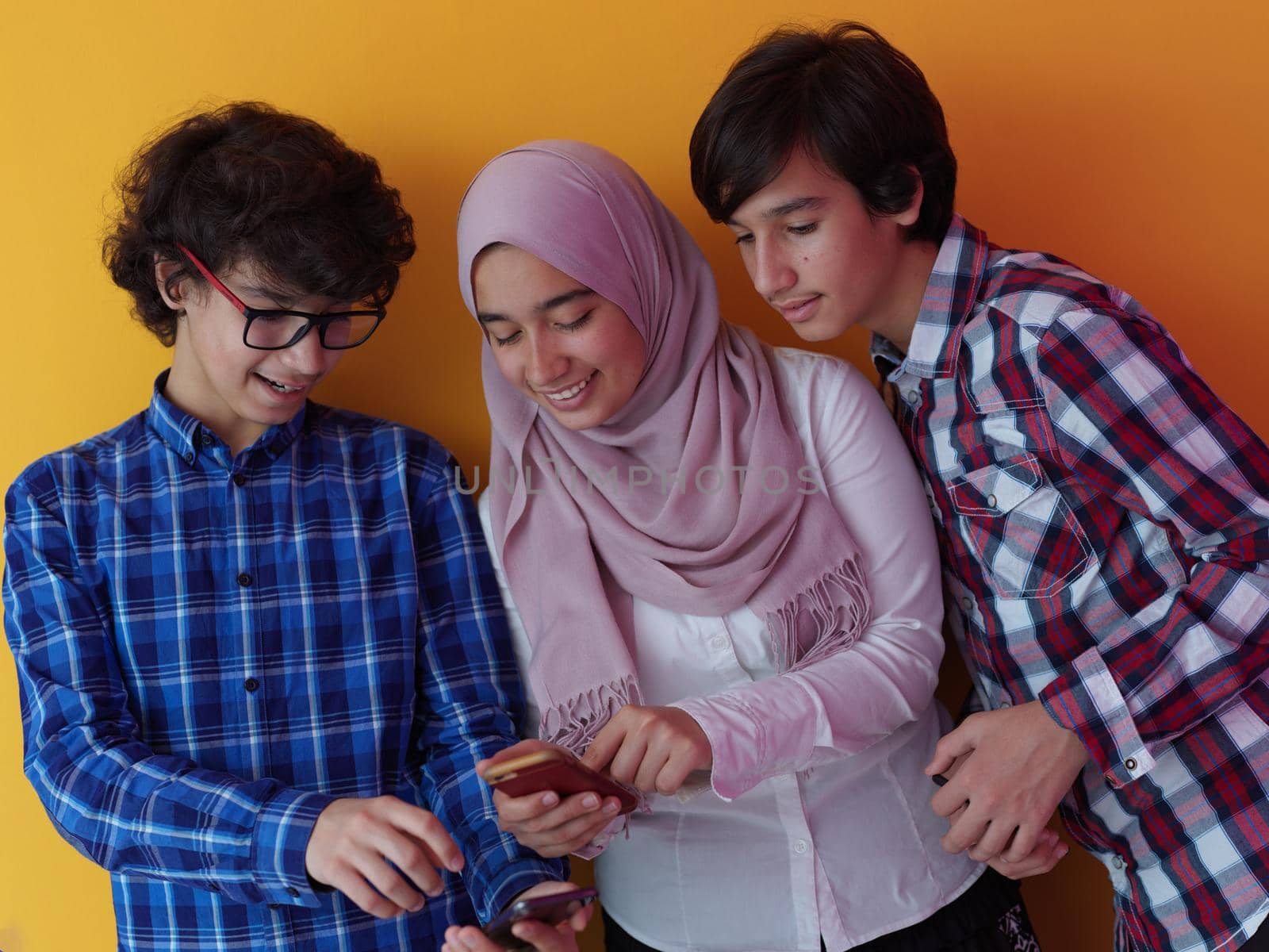 arab teenagers group using smart phones online education by dotshock
