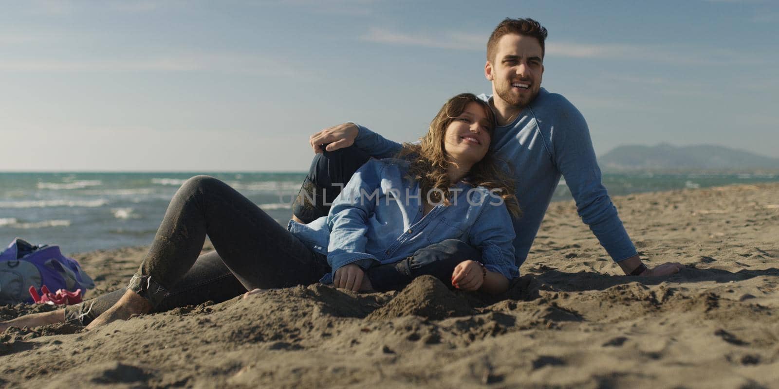Couple enjoying time together at beach by dotshock