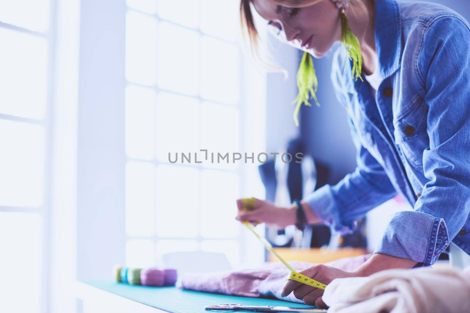 Fashion designer woman working on her designs in the studio.