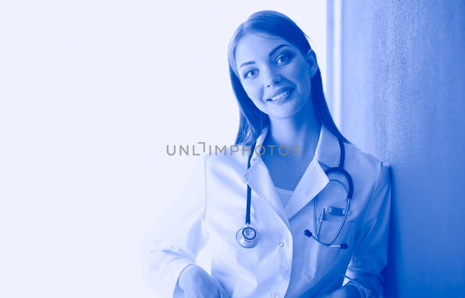 Female doctor using a digital tablet and standing on white background. Woman doctors