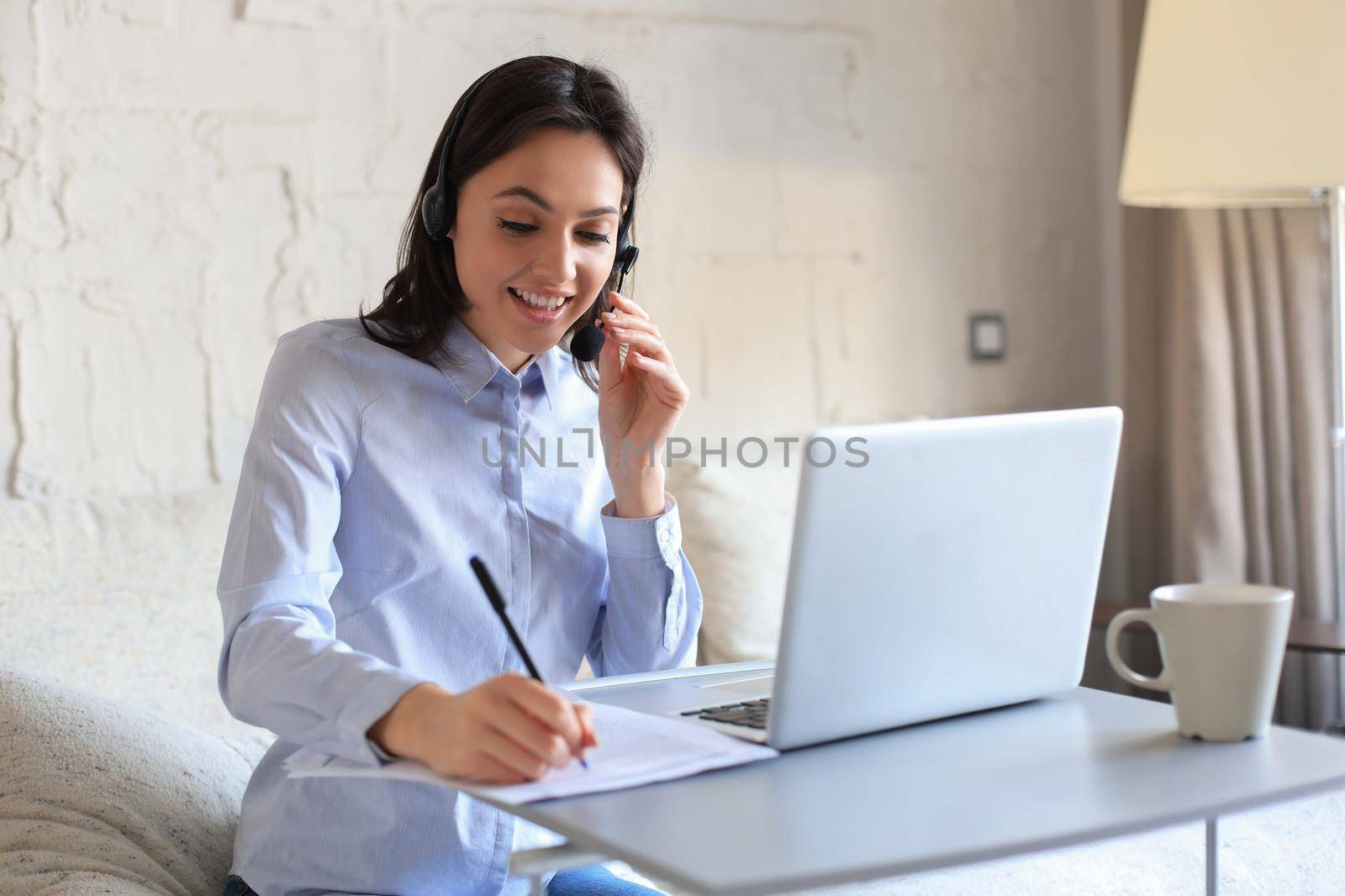 Freelance operator talking with headsets and consulting clients from home office