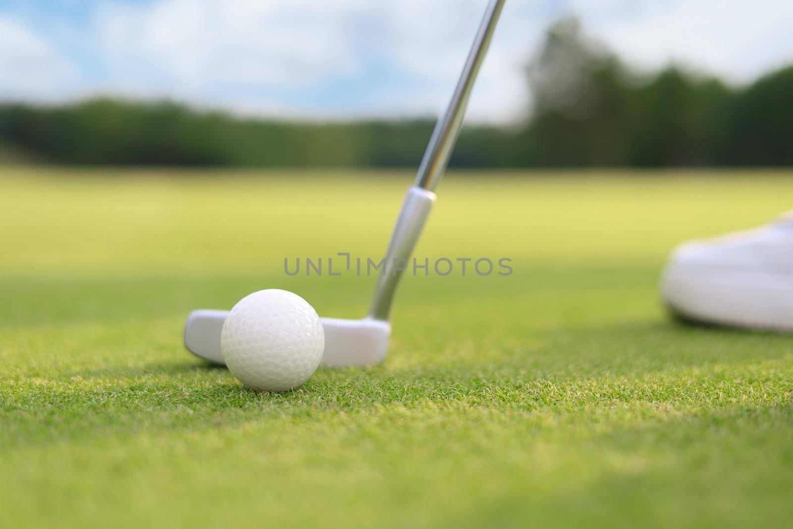 Golf approach shot with iron from fairway at sunny day. by tsyhun