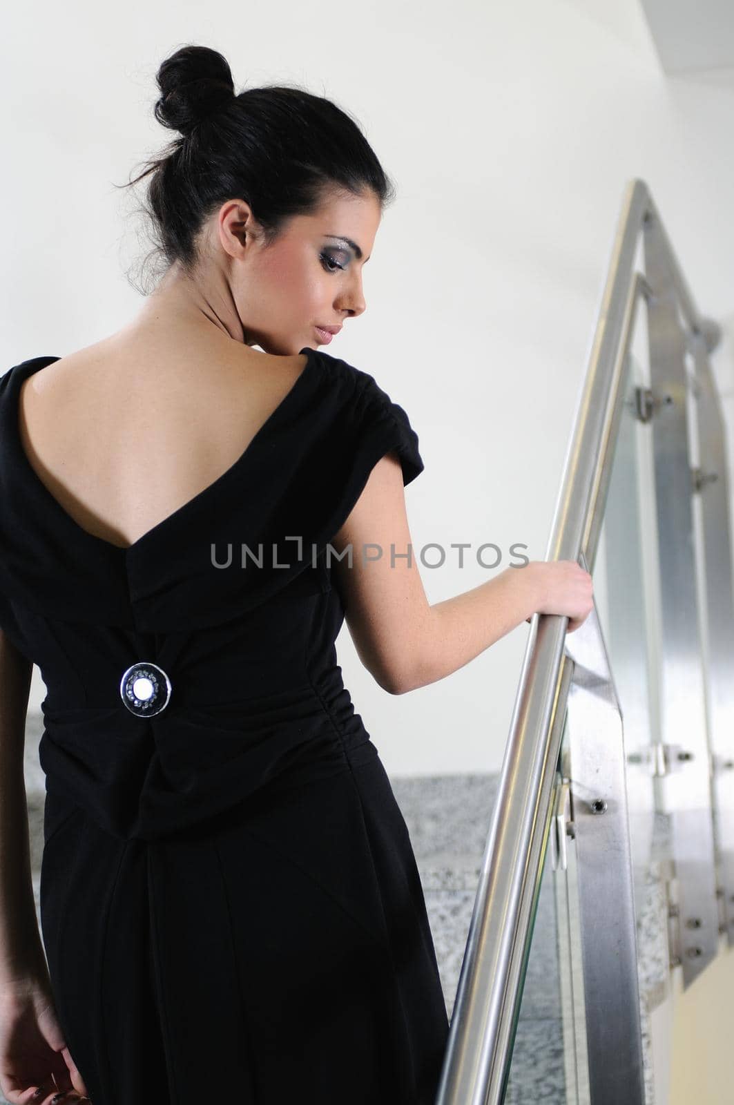 beautiful young lady in black dress shoot from back