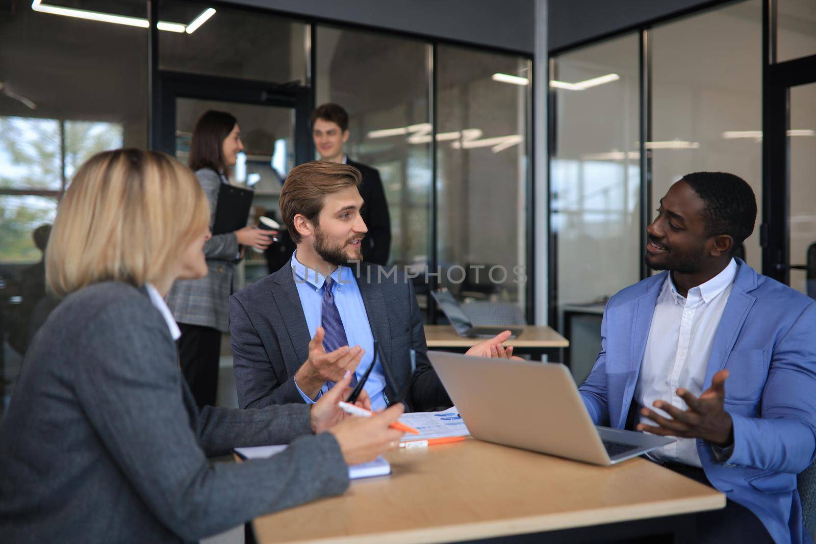 Business meeting - manager discussing work with his colleagues. by tsyhun