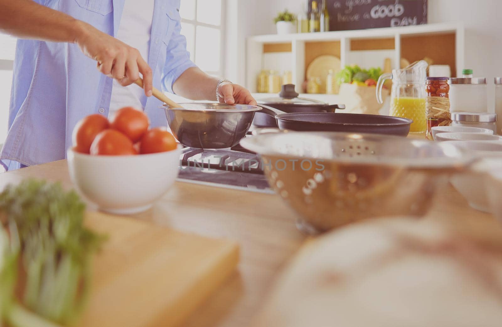 Man preparing delicious and healthy food in the home kitchen by lenets