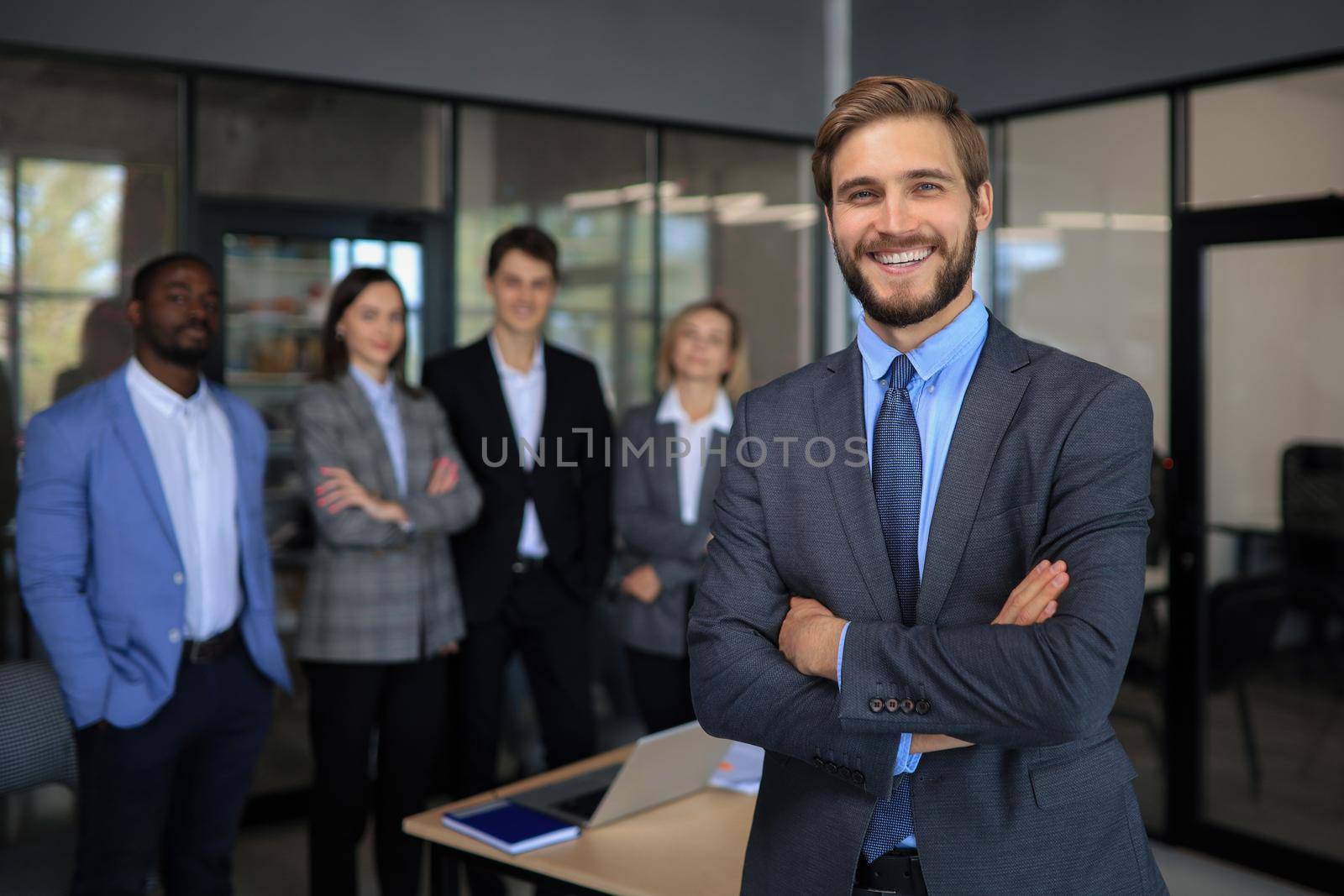 Businessman with colleagues in the background in office