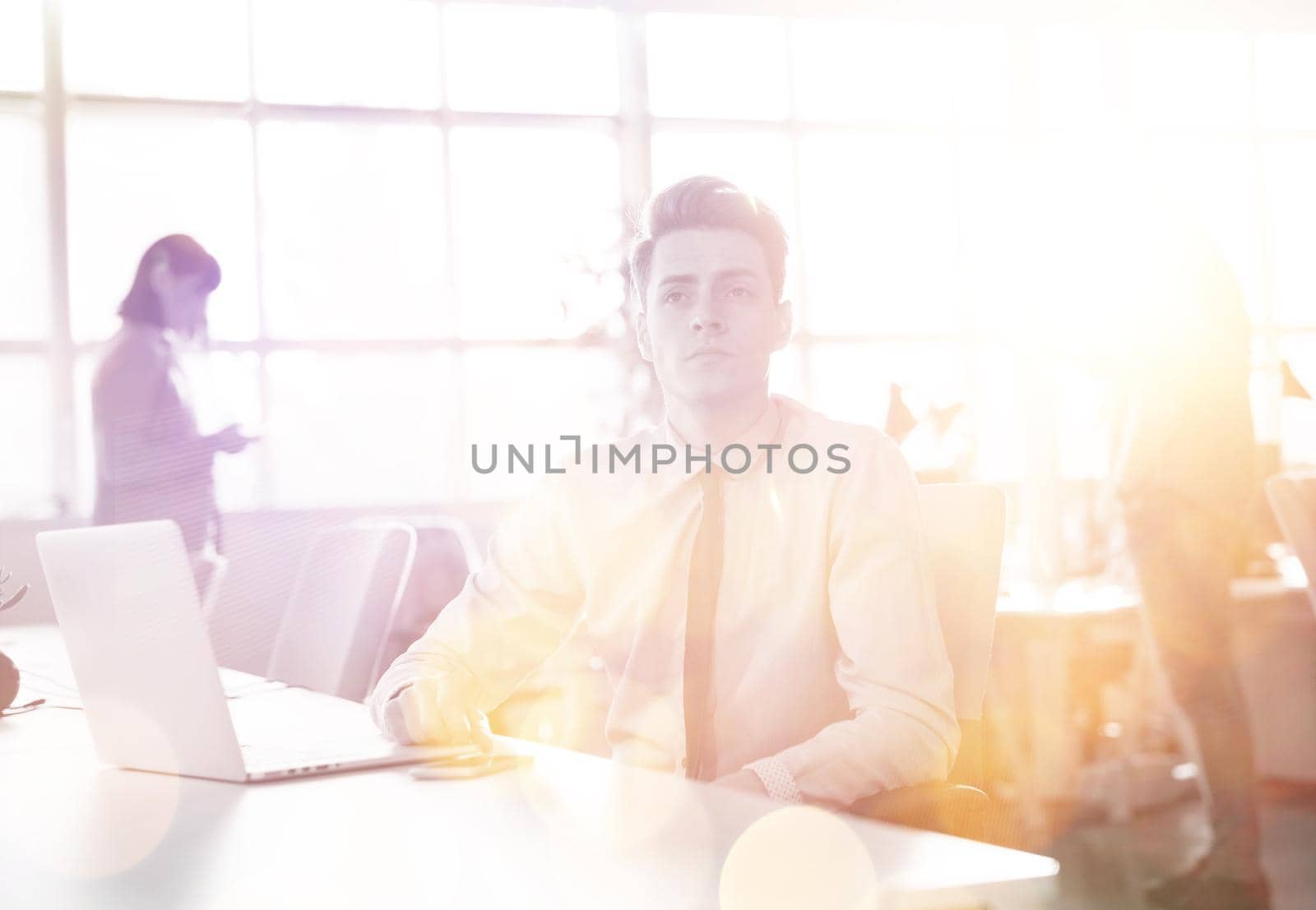 businessman working using a laptop in startup office by dotshock