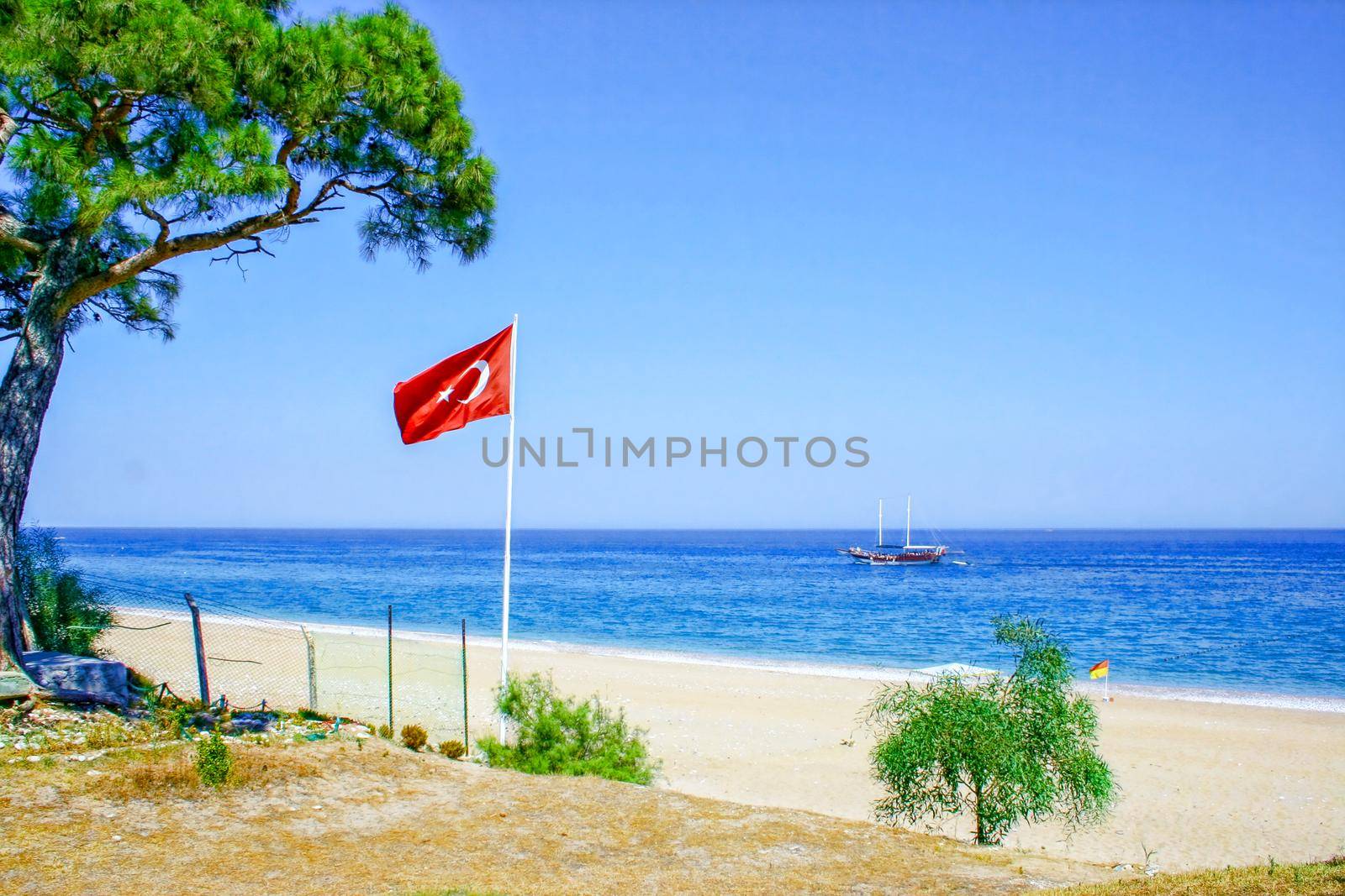 Turkey flag on the background of the sea and blue sky. In the summer while relaxing at sea.