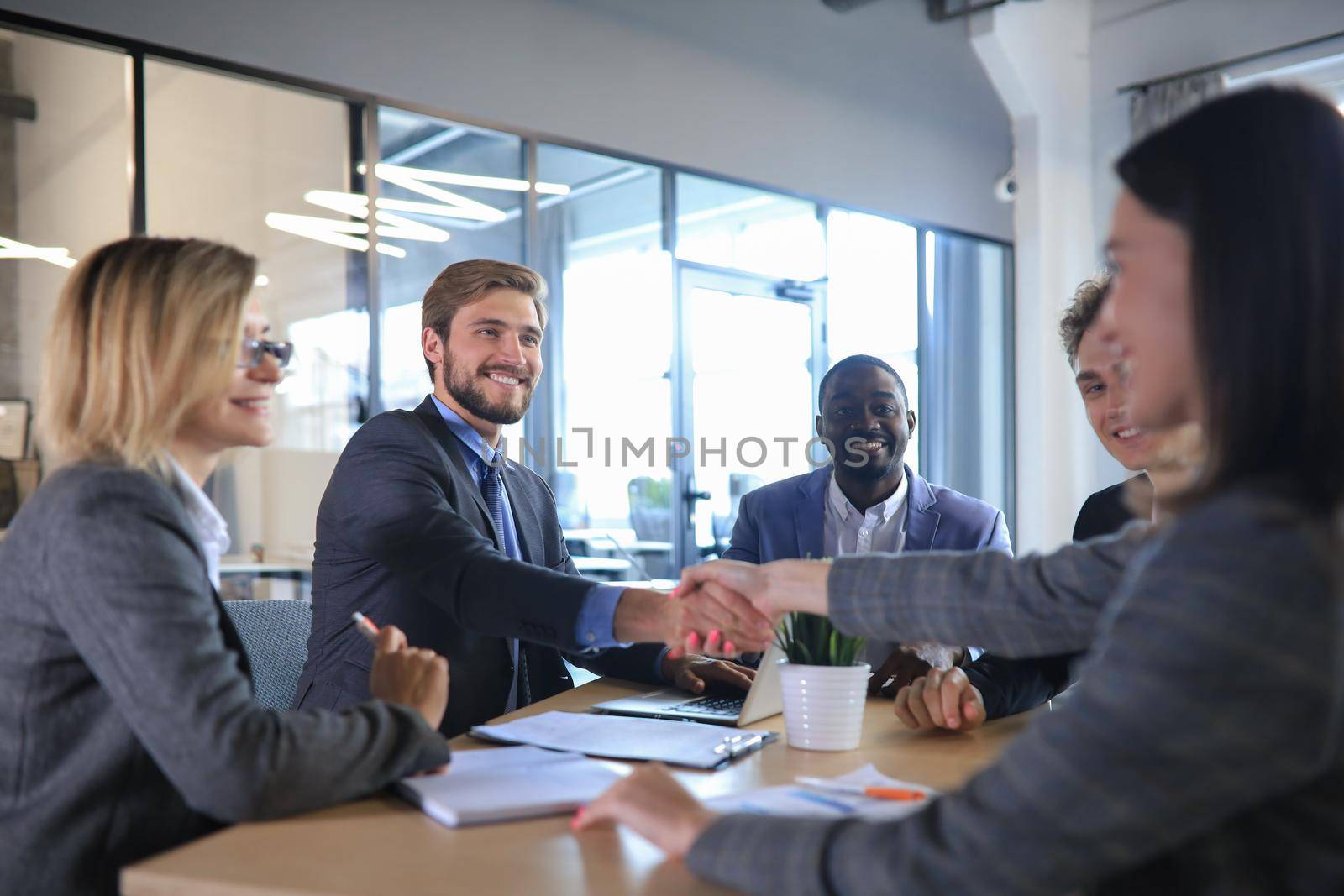 Job applicant having interview. Handshake while job interviewing. by tsyhun