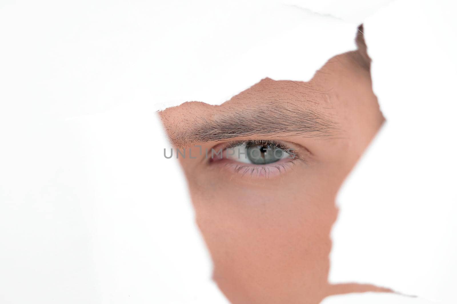 close up. businessman looking through a hole in the paper wall by asdf