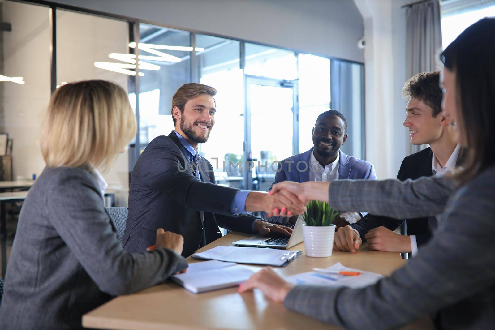 Job applicant having interview. Handshake while job interviewing. by tsyhun