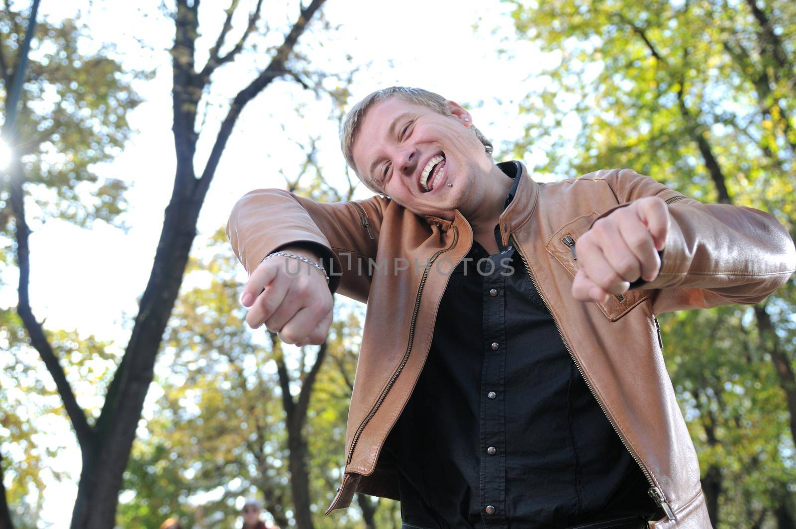 Handsome young man expressing his inner feeling outside in natur by dotshock