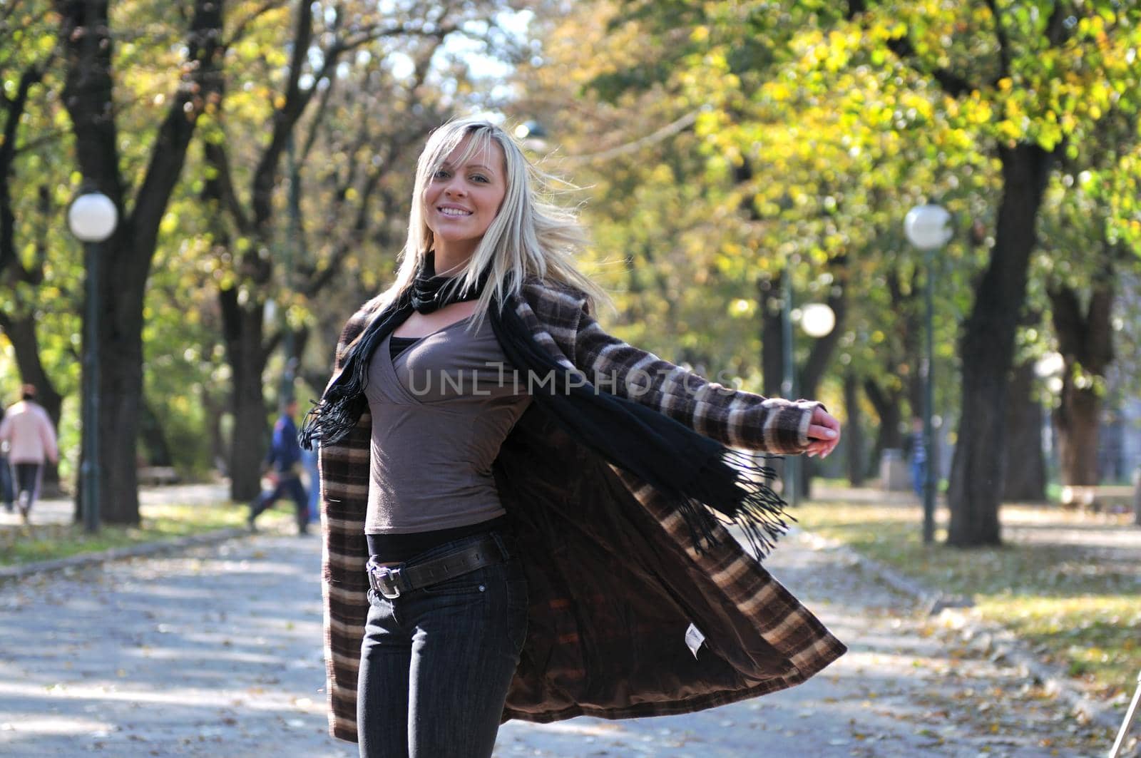 Cute young woman smiling outdoors in nature