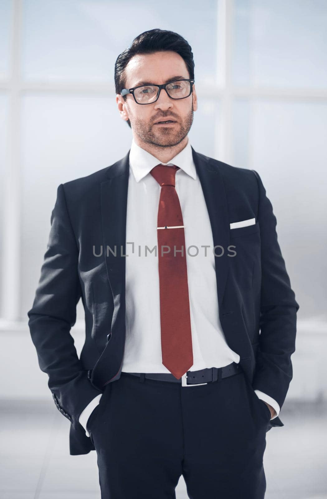 close up.handsome businessman standing in the office by asdf