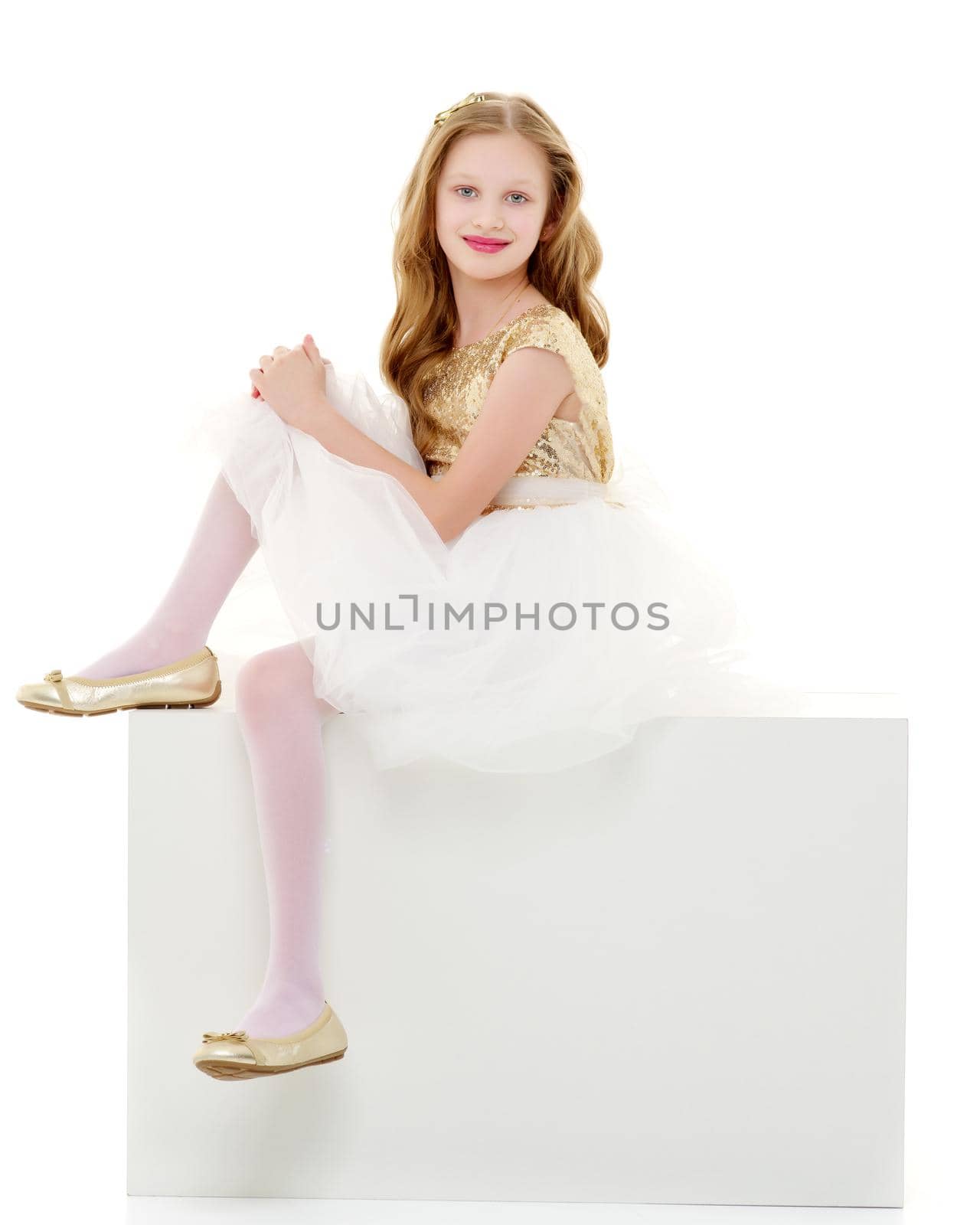 The little girl is sitting on a white banner. by kolesnikov_studio