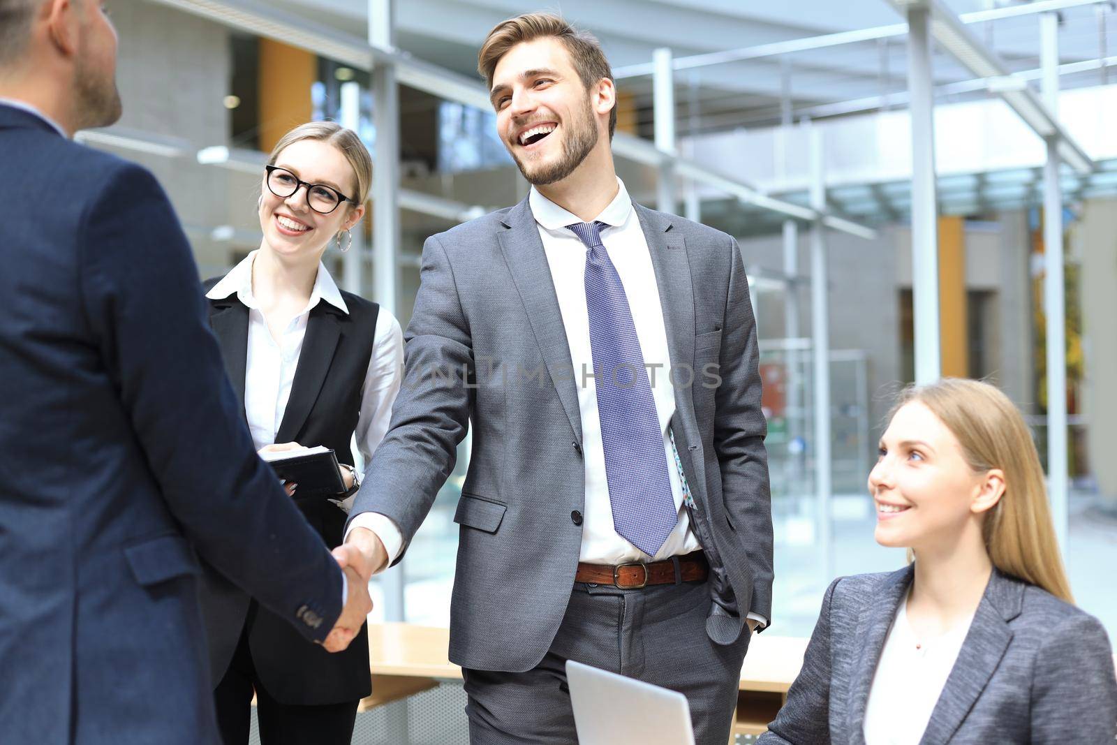 Business people shaking hands, finishing up a meeting. by tsyhun