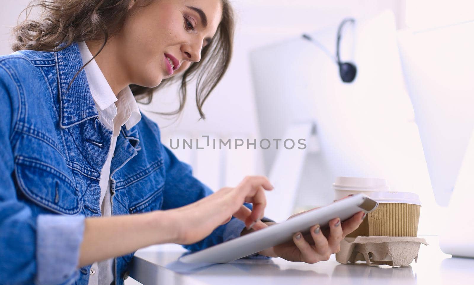 Young woman using digital tablet at office