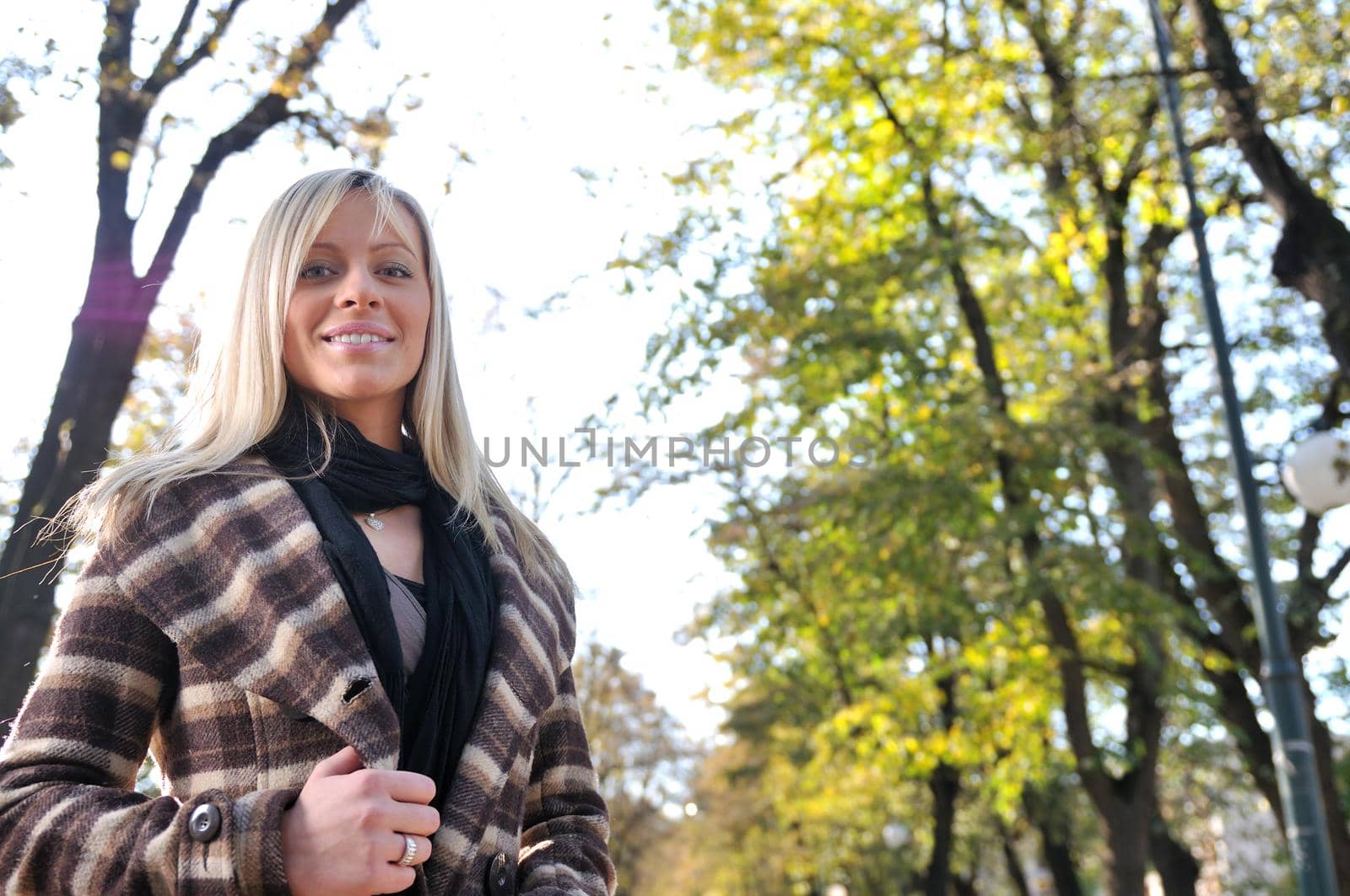 blonde Cute young woman smiling outdoors by dotshock