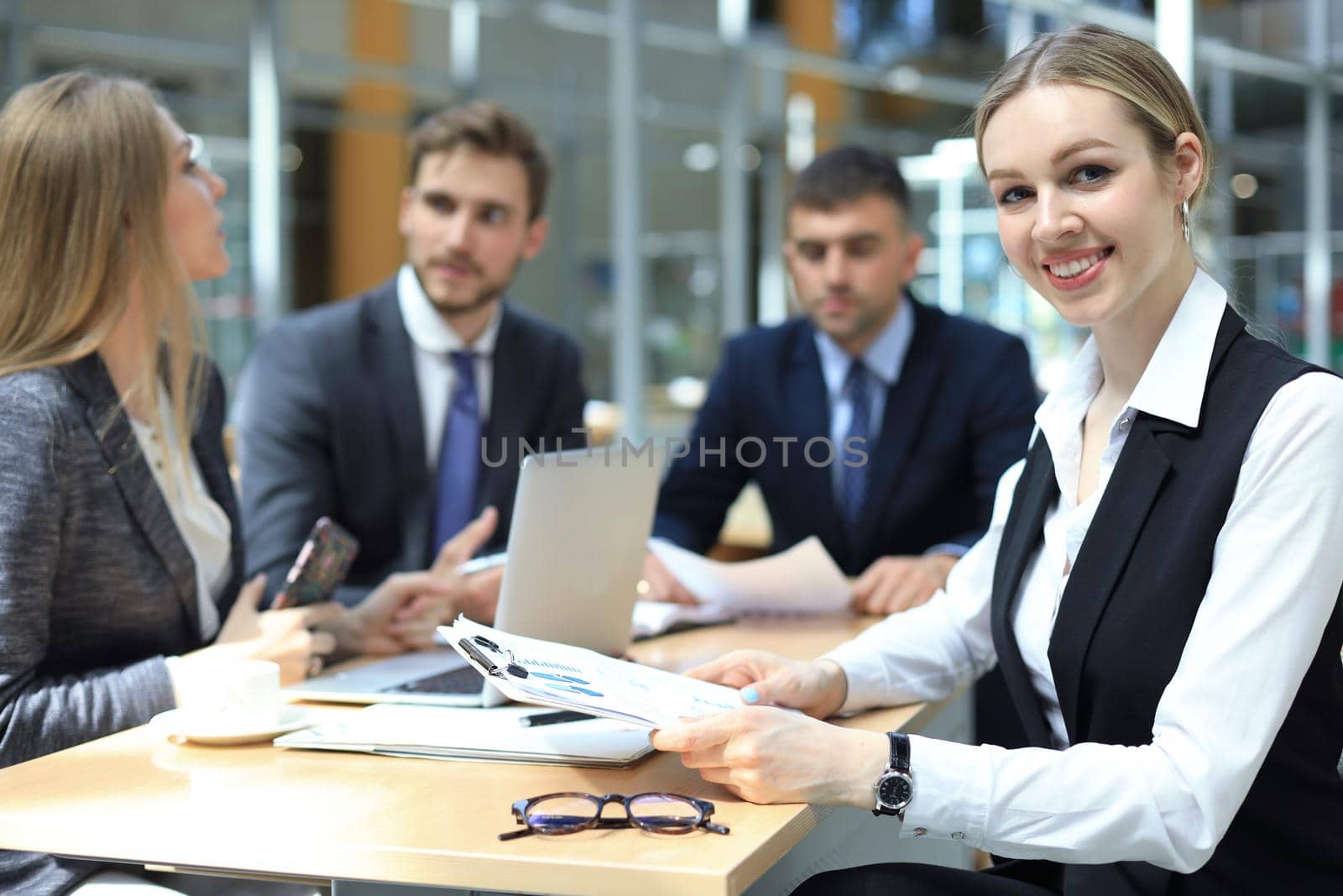 business woman with her staff, people group in background at modern bright office indoors